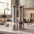 Pair of silver electronic salt and pepper mills in kitchen cupboard