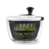 Black and white salad spinner with clear bowl, showing leafy greens inside