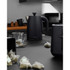 Black Salter microwave on kitchen worktop with control panel, plant and snack bowl beside