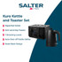 Black electric kettle on kitchen counter with glass cup and tea bags