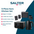 Black electric kettle on kitchen counter with glass cup and tea bags