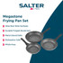 Set of speckled non-stick frying pans with cooked fish and peppers, kitchen background