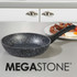 Black and white speckled non-stick frying pan with black handle on kitchen counter