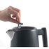 Grey metal storage canister with lid, countertop setting