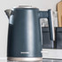 Matte dark grey Salter electric kettle with chrome details on kitchen counter