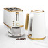 White and gold kettle and 2-slice toaster set on counter with coffee cup