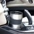 Stainless steel travel mug with black grip in car cup holder