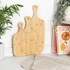 Set of three rectangular bamboo chopping boards with handles, plain finish.