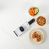 Salter hand-held mandoline slicer with black handle next to bowls of sliced vegetables and bruschetta.