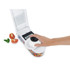 White vegetable chopper with diced fruit in container and fresh strawberries in front
