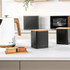 Black kitchen canister with wood lid on counter, modern style, suitable for tea, coffee or sugar