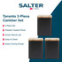 Set of two black metal storage canisters with wooden lids on kitchen worktop