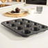 12-cup non-stick black muffin tray on kitchen worktop