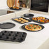 12-cup black speckled non-stick muffin tray shown at an angle