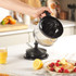 Electric citrus juicer in black with clear jug and measurement markings, handle on right