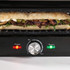 Close-up of black and silver electric grill handle with adjustable heat control