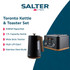 Black kettle, toaster, microwave and storage canisters with wooden accents on kitchen counter