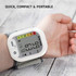 Wrist blood pressure monitor on arm showing display, compact portable design