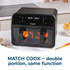 Black digital air fryer with sweet potato fries in one drawer, hand removing divider