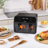 Black Salter air fryer with digital display, open basket with cooked roast potatoes