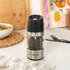 Electric pepper grinder with stainless steel body on kitchen counter