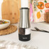 Stainless steel electric salt and pepper grinder with Salter logo, on kitchen worktop.