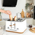 White 4-slice toaster with wooden accents on kitchen counter, hand adjusting controls
