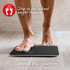 Person stepping onto black digital bathroom scale with toughened glass platform.