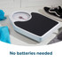 Mechanical bathroom scale with black platform viewed from above, next to black trainers and blue towel.