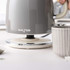 Grey toaster with removable crumb tray shown open on kitchen counter