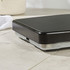 Mechanical bathroom scale with black textured platform and rose gold dial, shown upright