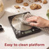 Digital kitchen scale weighing flour in glass bowl, baking ingredients nearby