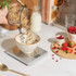 Silver digital kitchen scale weighing dark chocolate pieces