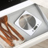 White digital kitchen scale with strawberries on weighing platform, reading 176g