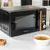 Black microwave oven with wood-effect handle, Salter branding, shown from front angle