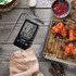 Salter digital meat thermometer with probe next to cooked chicken wings on tray