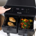 Salter dual air fryer with chocolate muffins baking in two baskets, shown with mixing bowl and ingredients.