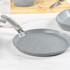 Grey speckled crepe pan with handle on kitchen worktop