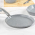 Grey non-stick crepe pan with speckled finish, shown from side angle