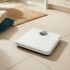 White mechanical bathroom scale on tiled floor, angled view