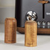 Set of two black storage canisters with wooden lids on kitchen worktop