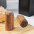 Set of two Salter wooden salt and pepper shakers beside matt black toaster