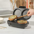 Black dual snack maker open with cooked vegetable muffin being removed