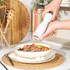 White Salter mill in use seasoning steak salad in kitchen setting