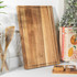 Large rectangular wooden chopping board standing upright on kitchen counter