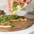 Round wooden serving board with handle, natural finish