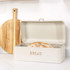 Cream metal bread bin with rose gold handle and embossed 'BREAD' text on front
