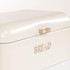 Cream metal bread bin with gold handle and raised BREAD lettering, shown from front angle