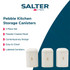 Set of cream kitchen canisters with rose gold letters for sugar, coffee and tea on worktop