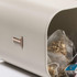 Cream metal storage tin with rose gold handle, containing tea bags